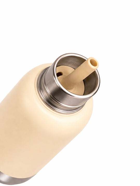 Close-up top view of the Pijo double-wall insulated kids water bottle, showing the stainless steel interior and removable pink silicone straw for easy cleaning.