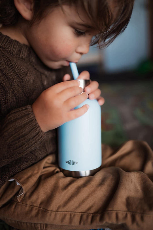 A kid drinking from his koala milo pijo bottle