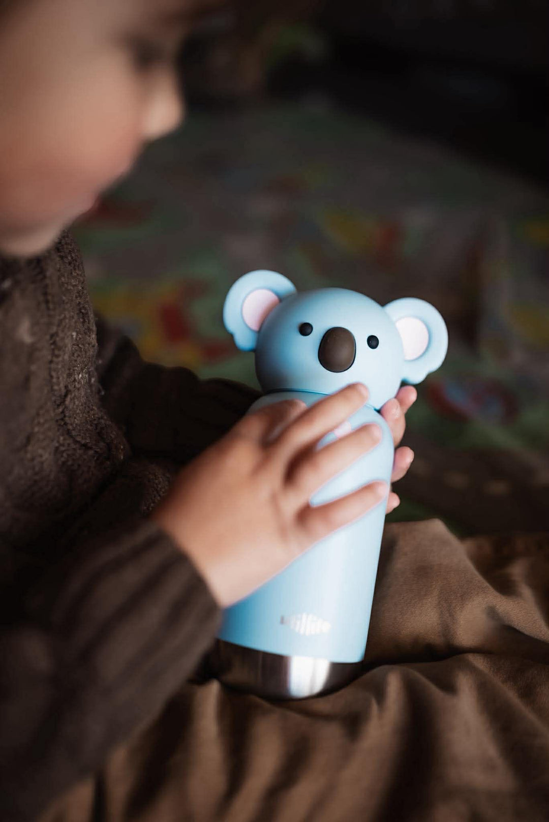 A kid holding his koala milo pijo bottle